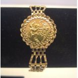 Gold half sovereign (1982) set in a 9ct mount and 4 bar gate bracelet with heart padlock clasp &