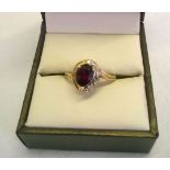 Hallmarked 9ct gold dress ring set with a teardrop garnet with diamonds to one side - one small