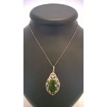 A large silver marcasite pendant approx 5cm x 2.5cm, set with large green stone.