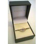 An 18ct gold and diamond ring with one central stone and two smaller stones. Illusion set, approx