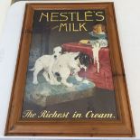 A modern pine framed Nestles milk advertising poster approx 59 x 41cm