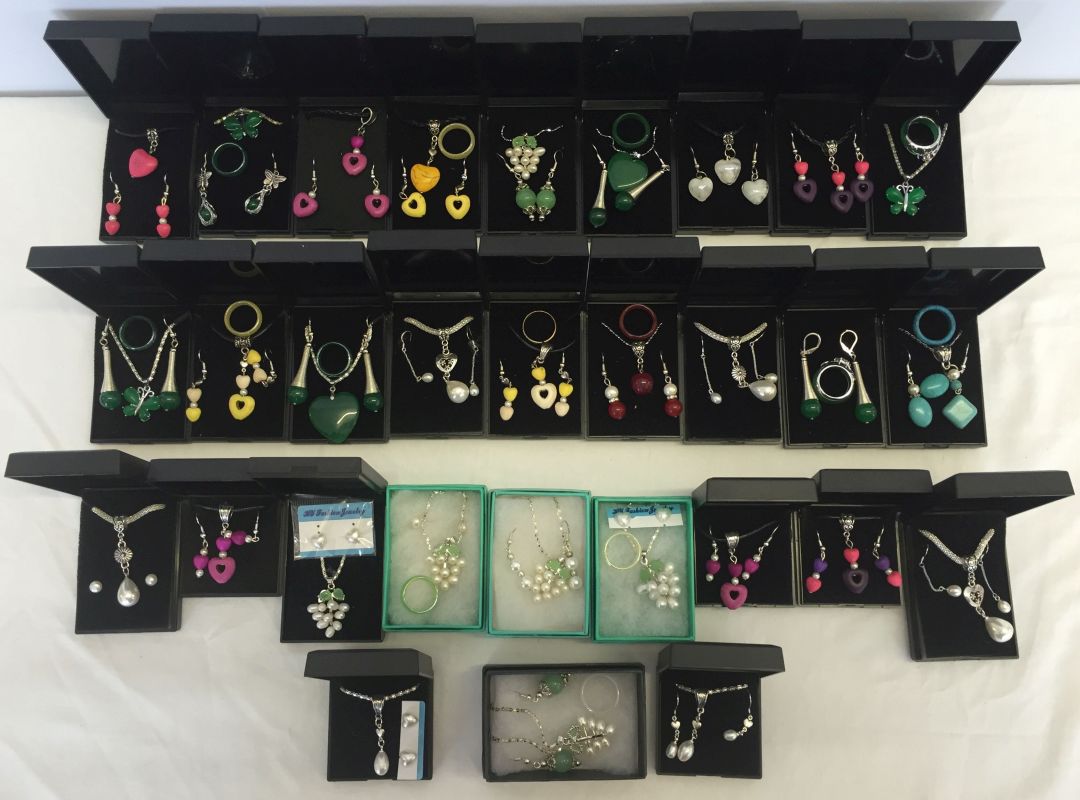 A collection of 30 two and three piece jewellery sets with mixed gemstones.