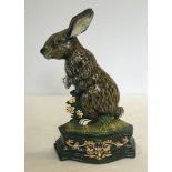 A painted cast iron door stop in the shape of a Hare