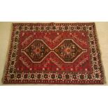 A vintage wool rug in red, geometric design. 150 x 107cm.