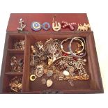 A wooden box of costume jewellery inc. vintage diamante brooches