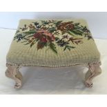 A vintage footstool with tapestry top and shabby chic paintwork