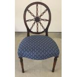 A curved wheel back style chair with central boss decoration and blue upholstery