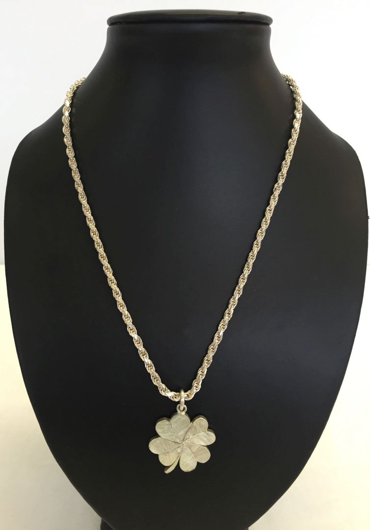 A heavy white metal clover leaf pendant on a 18 inch chain marked 925. Clover pendant unmarked.