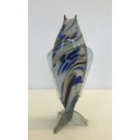 A multicoloured Murano glass fish with a 3 way tail, in shades of yellow, white and blue. Approx