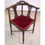 A Victorian corner chair with turned legs, cross stretcher and lyre back.
