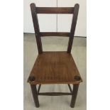 A wooden childs chair