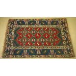 A large vintage wool rug in red & dark blue colour geometric pattern. 230 x 150cm.