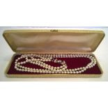 A double string of vintage simulated pearls with diamante clasp in c1950s case.