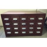 A large wooden 20 drawer filing cabinet.