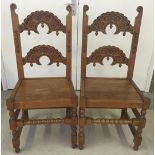 A pair of carved light oak chairs with acorn decoration. Reproductions from an early 17th century