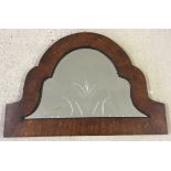 An ornately shaped oak framed mirror with floral shaped design cut into glass approx 57 x 40cm