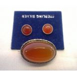 A silver & carnelian stone brooch and earrings set.