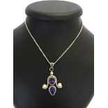 A Lapiz Lazuli and pearl pendant set in silver on a 22 inch silver chain.