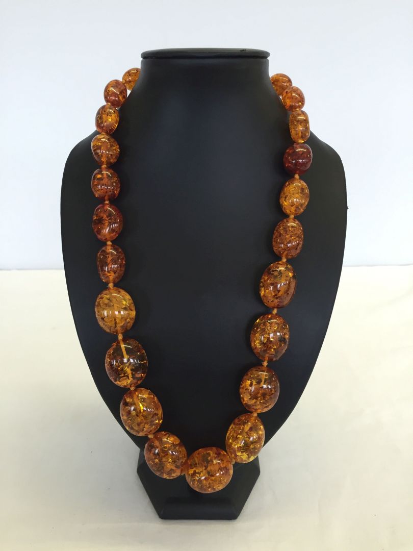 A 24 inch Baltic amber necklace, regular oval beads. Weight approx 122.3g bead sizes 1.5cm to 3cm