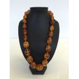 A 24 inch Baltic amber necklace, regular oval beads. Weight approx 122.3g bead sizes 1.5cm to 3cm