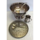 A silver plated punch bowl, ladle, tray, tankard and salad servers