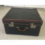 A vintage green leather bound travelling case