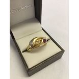 An early 20th century 18ct gold signet ring size Z in the form of 2 entwined serpents. Each set with