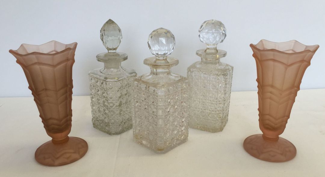 3 glass/crystal decanters together with a pair of moulded pink glass vases.