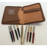 A writing case containing 2 fountain pens, 2 ball points, a pencil and a ladies American ball point,