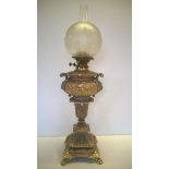 A very large ornate cast vintage iron oil lamp with decorative bird glass shade, two tone