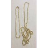 2 strands of faux pearls. First 54 inches long and second 24inches long.