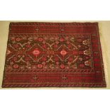 A vintage wool rug in deep reds, geometric design. 137 x 97cm.