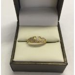 An antique gold and diamond ring set with 9 diamonds, Hallmark rubbed, tests as 18ct gold size J.