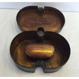 A kidney shaped metal warmer box