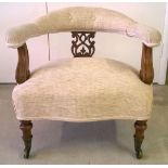 Victorian nursing chair with fretwork back & biscuit coloured upholstery, turned legs and brass