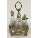 A Victorian 4 bottle cruet in silver plated base.