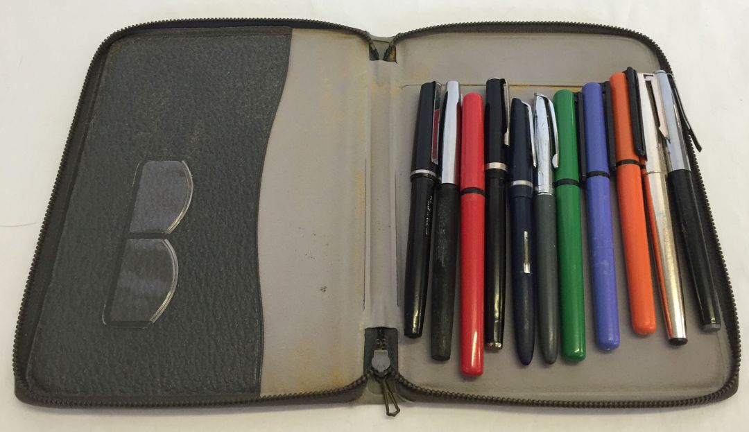 A writing case containing a collection of vintage pens to include Watermans, Skywriter and Conway