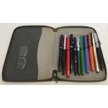 A writing case containing a collection of vintage pens to include Watermans, Skywriter and Conway