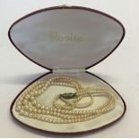 A cased set of Rosita 3 strand faux pearls.