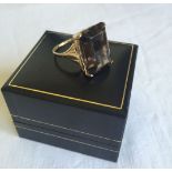 A 9ct gold dress ring set with a large baguette cut smokey quartz stone. Size O, total weight