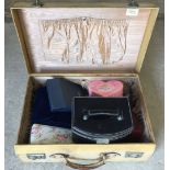 A ladies vintage animal skin suitcase containing a quantity of jewellery boxes and costume