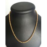 A 20" belcher chain tests as 12ct gold, weight approx 23g. Indistinct mark.