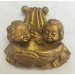 A gold painted cherub plaster wall plaque. a/f repair to top.