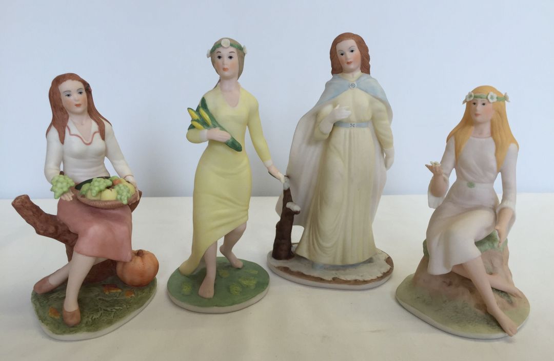 A set of 4 ceramic figures made by Franklin Mint depicting the four seasons