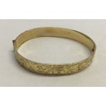 A 9ct rolled gold bangle.