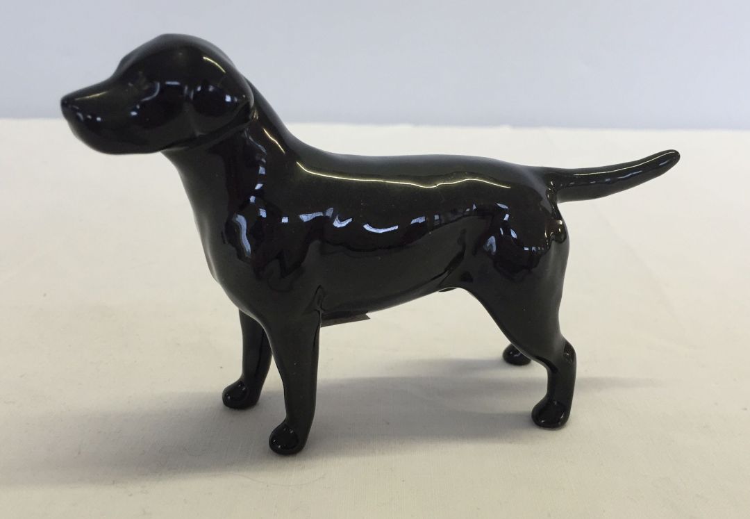 A small Beswick black Labrador dog figurine approx 12cm long.