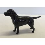 A small Beswick black Labrador dog figurine approx 12cm long.