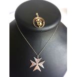 A Maltese silver pendant in the shape of a Maltese cross on a 925 silver chain. Together with a