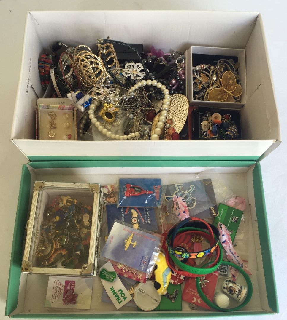 A box of costume jewellery, together with a tray of collectors pin badges and charity rubber