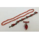 3 items of Coral jewellery comprising a matching brooch and bracelet, decorated with coral beads